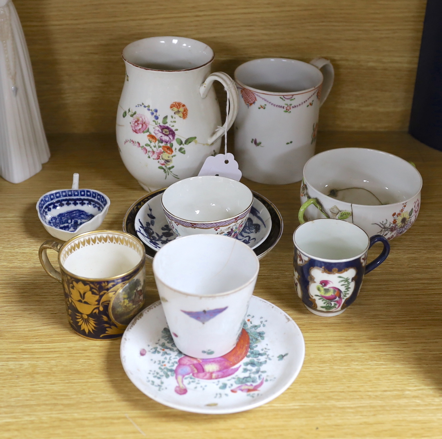 A Chelsea ecuelle base with twig handles painted with Meissen style flowers, red anchor mark, a Derby mug painted with flowers and scattered sprigs, a Coalport mug in the Chinese export style, a Caughley leaf shaped pick